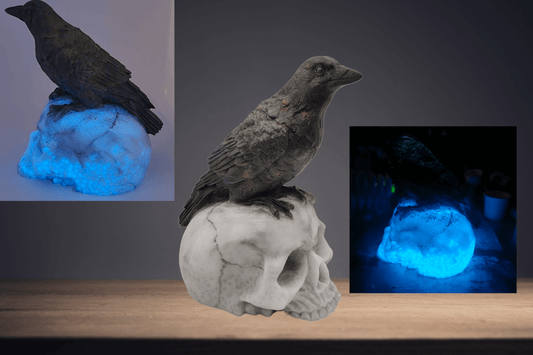Raven sitting on skull resin statue- glow in the dark